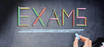 Exams written on a chalkboard